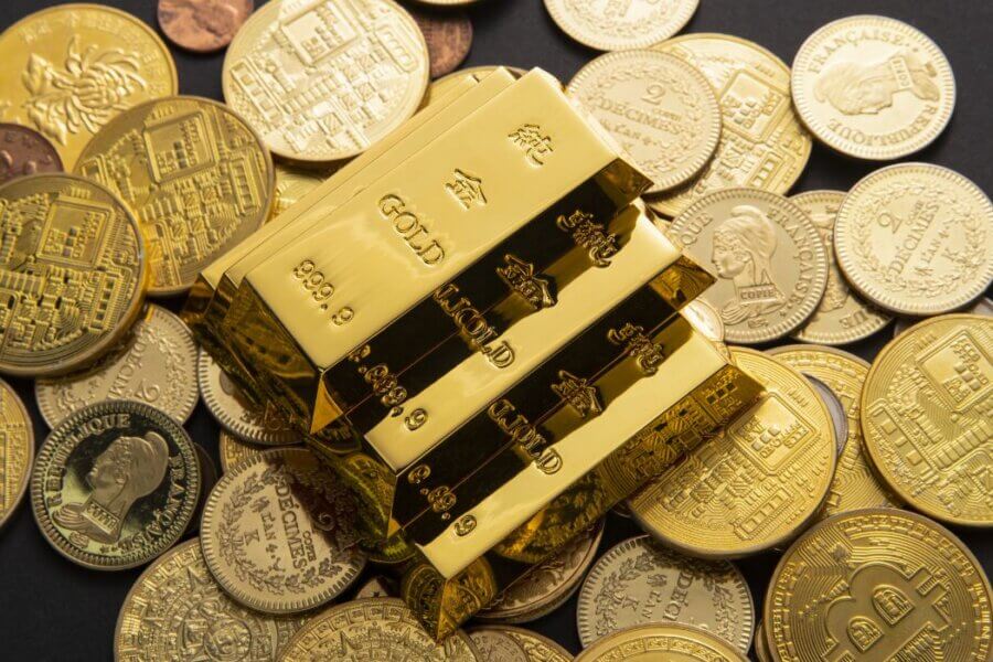 Gold bars on coins illustrating a gold tax haven and the hidden wealth advantage of tax-free gold