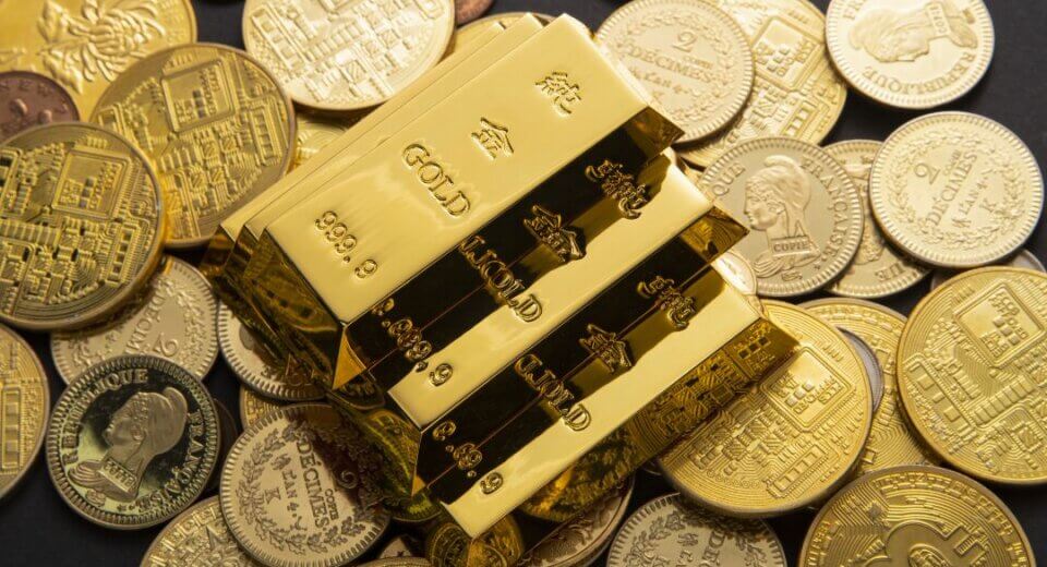Gold bars on coins illustrating a gold tax haven and the hidden wealth advantage of tax-free gold