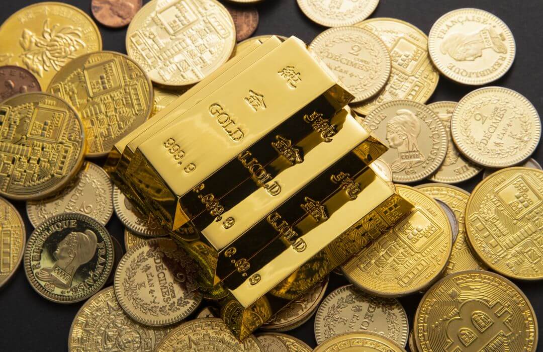 Gold bars on coins illustrating a gold tax haven and the hidden wealth advantage of tax-free gold