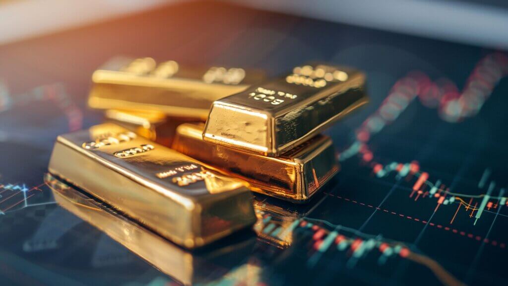 Gold bars placed over a financial market chart — physical gold as a safe haven asset during economic cycles, inflation, financial crises, and currency instability.