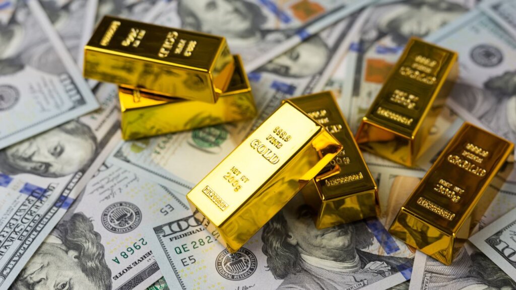 Gold bars placed on US dollar bills symbolizing tangible wealth, inflation protection, and investor flight to safe haven assets during financial crises